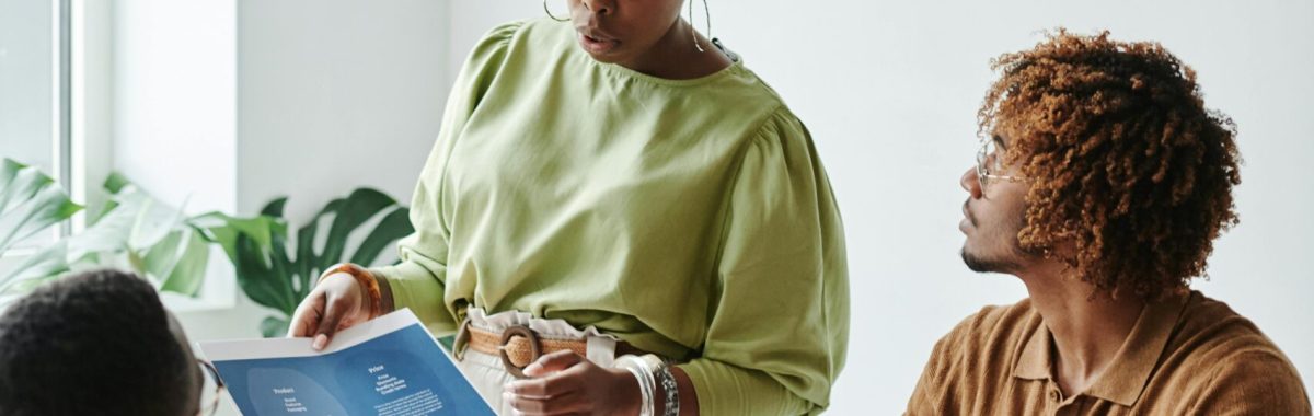 Diverse team collaborating in a bright, modern office setting with documents.